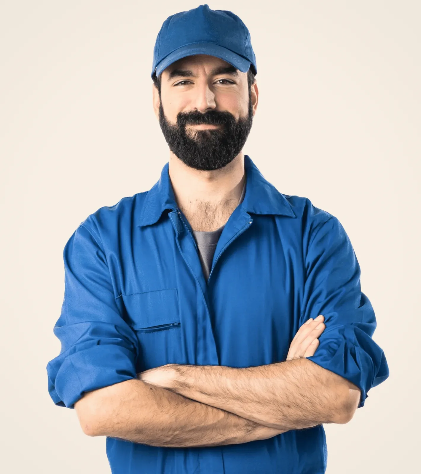 A man in a blue work shirt, arms crossed.