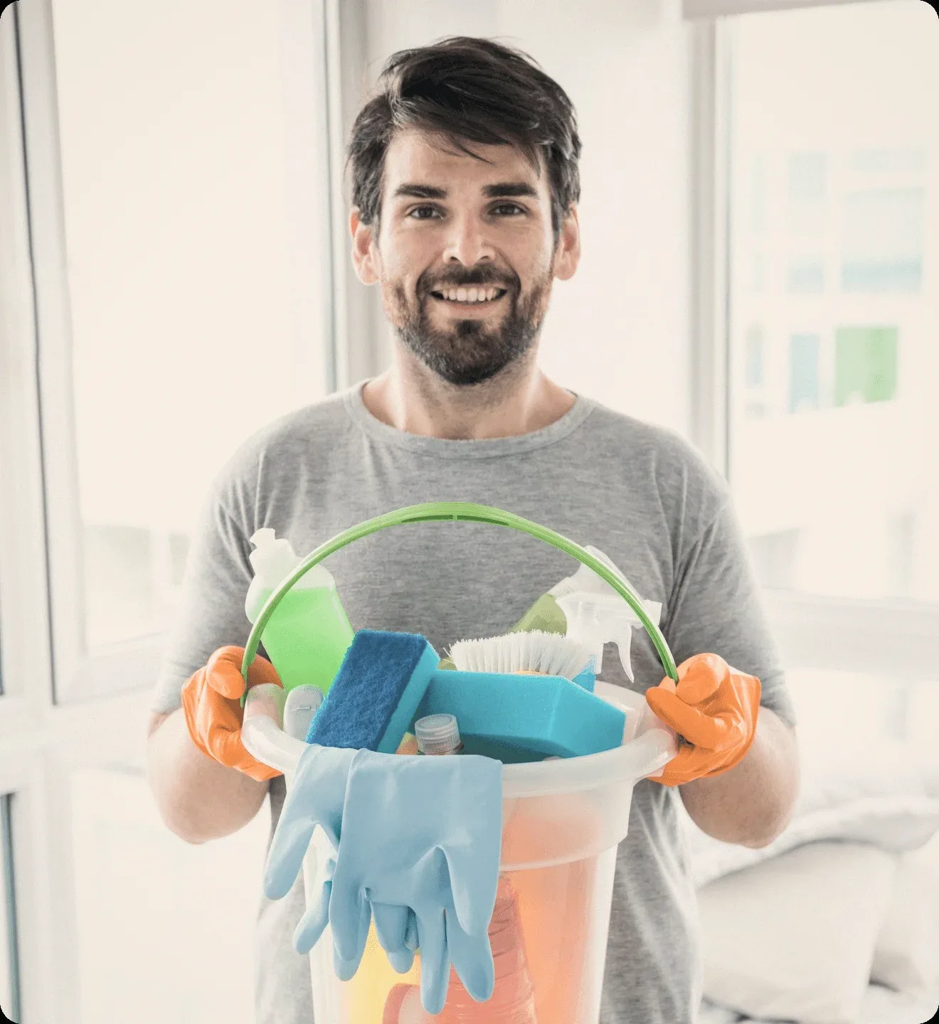 A cleaner holding a bucket of cleaning supplies.