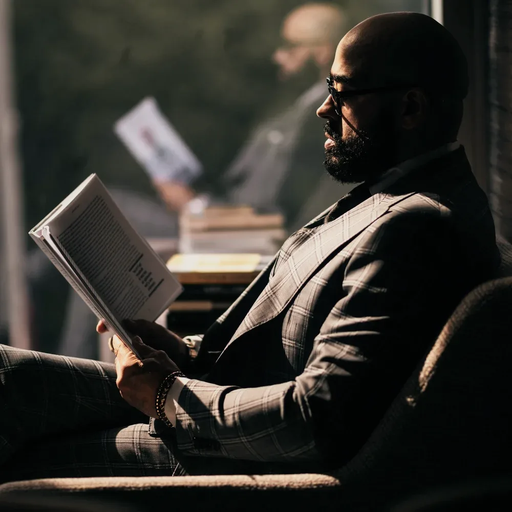 A man reading in a dark room.
