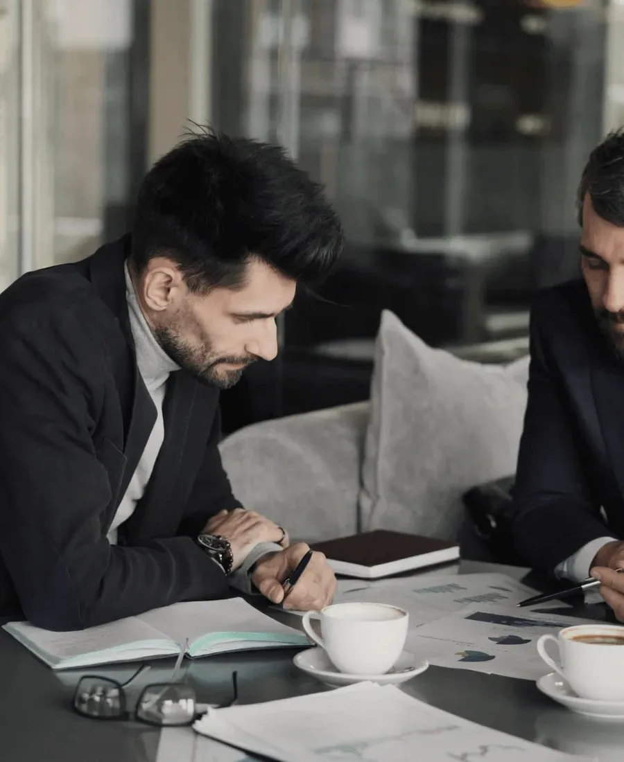 Two men at a laptop.