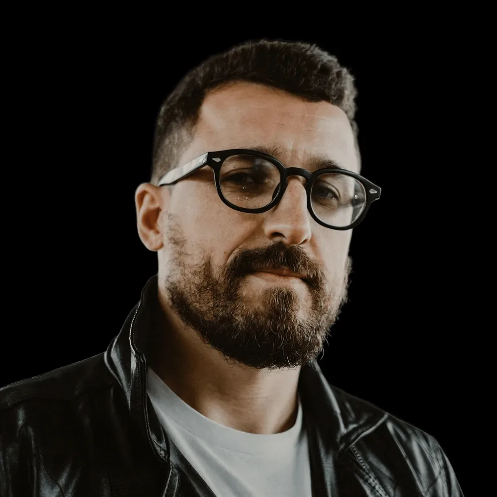 A bearded man in glasses.