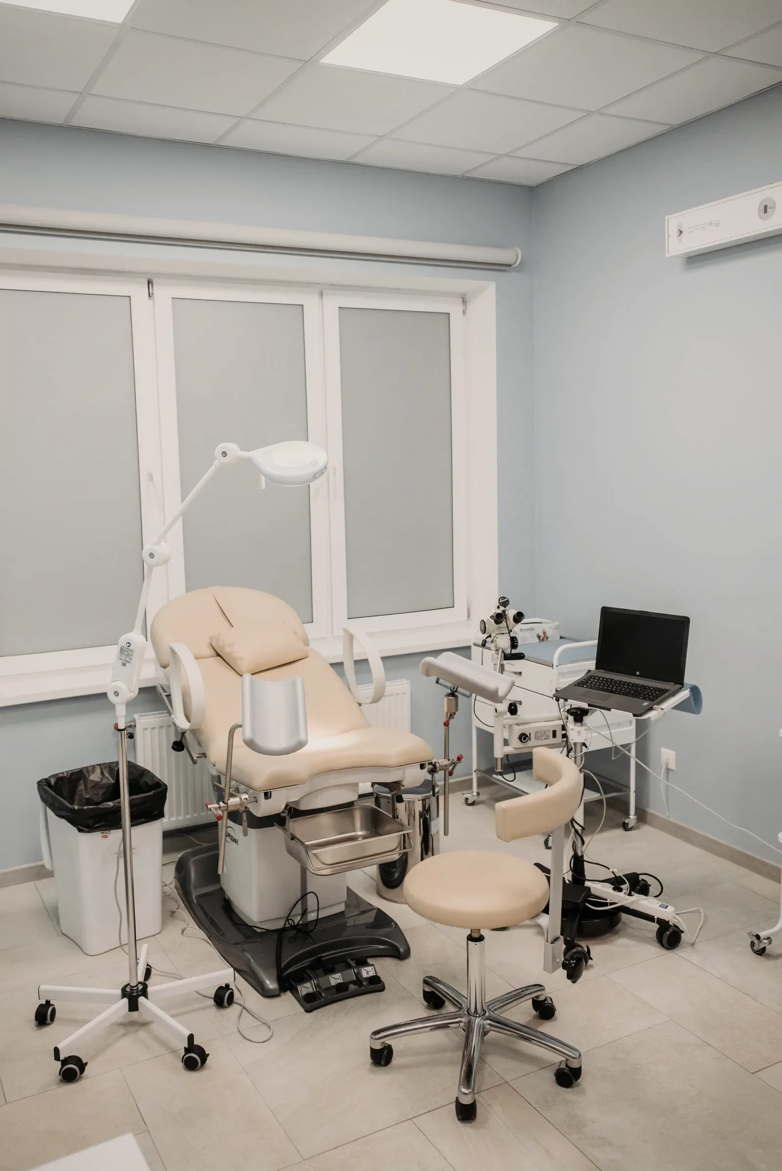 A treatment room with a chair, a lamp and nothing else in view.