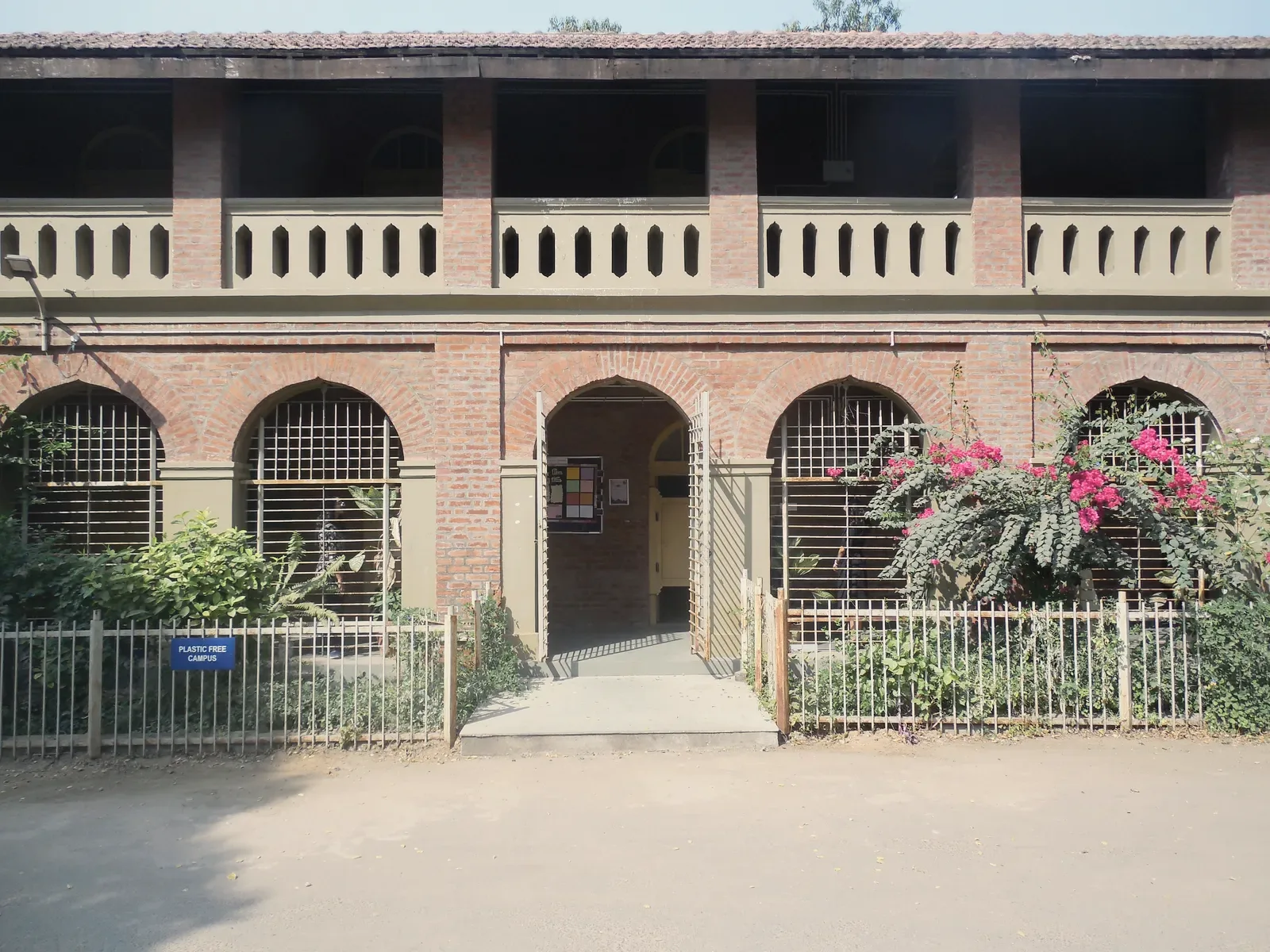 The grounds at a school entrance, photographed wide in daylight.