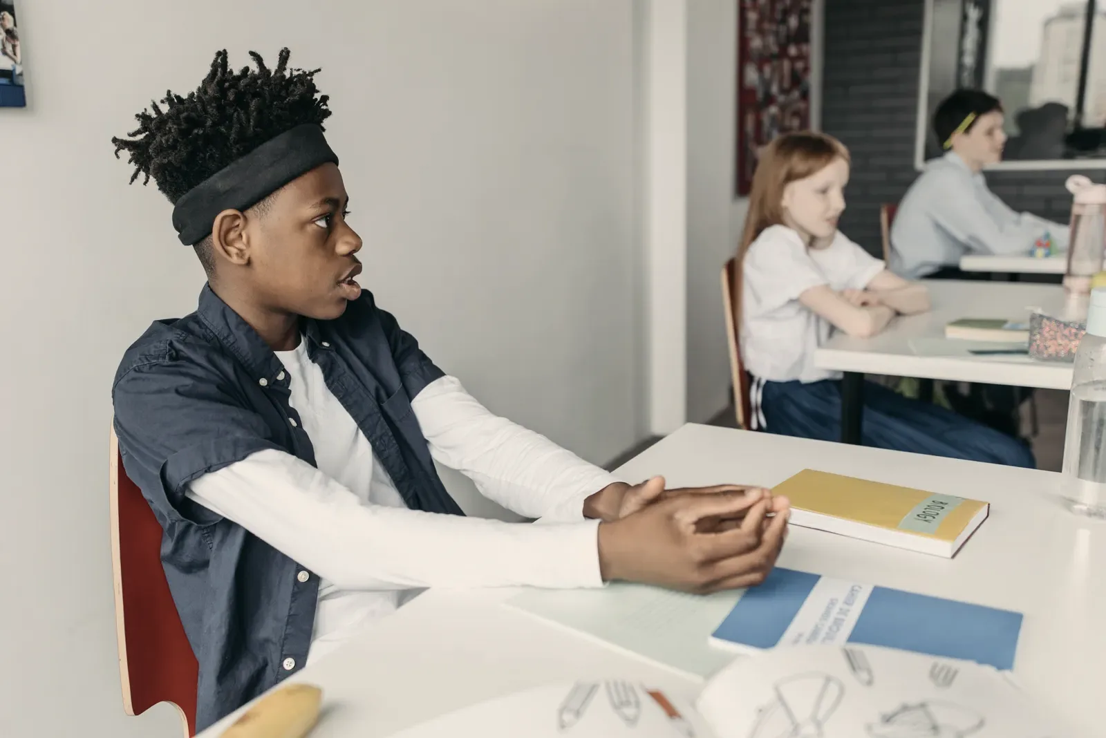 A classroom in session, photographed candidly from the back of the room.