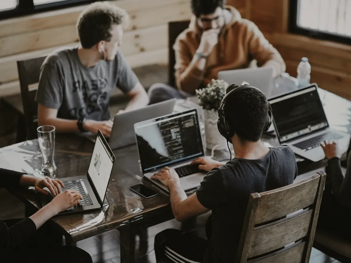 A team at laptops in a coworking space.