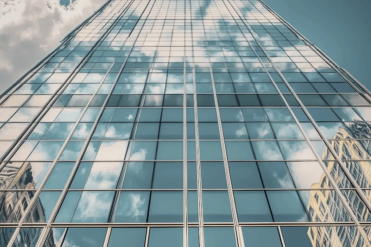 A glass tower reflecting the sky.