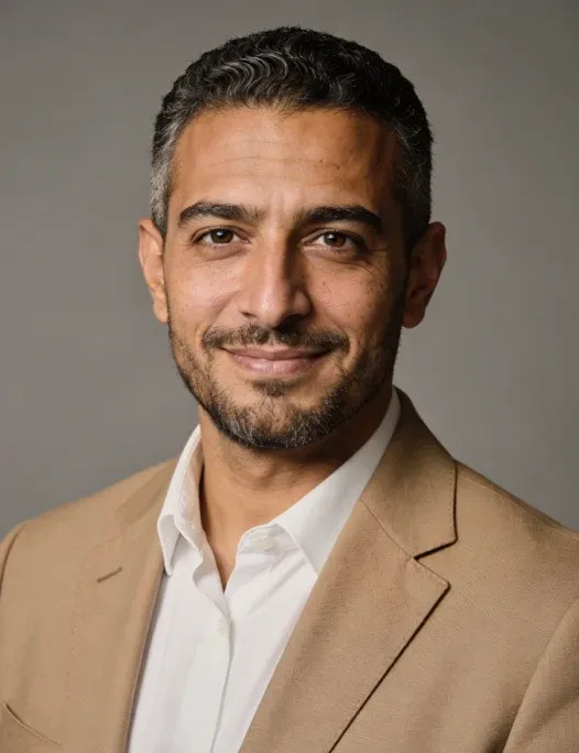 A man in a tan jacket.