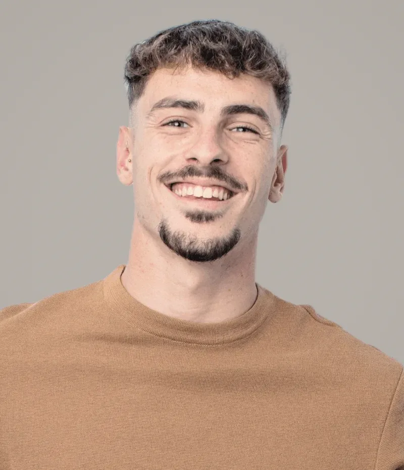 A young man in a brown top.
