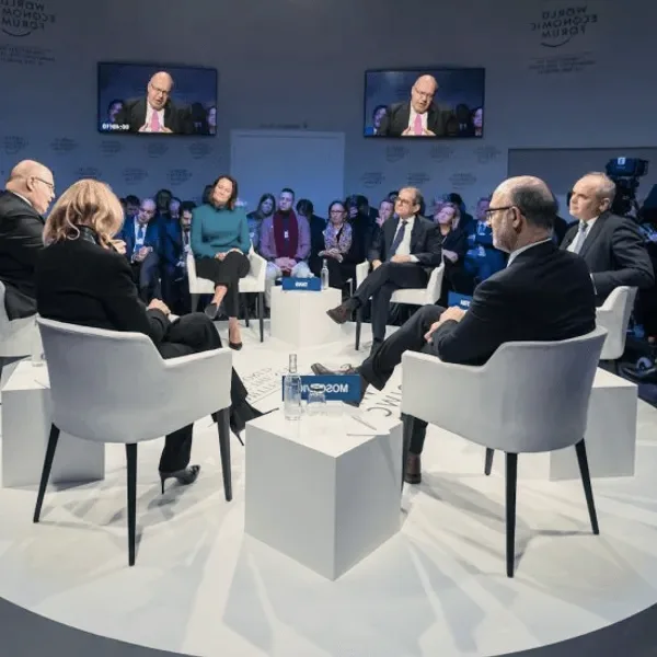A panel discussion on a blue stage.