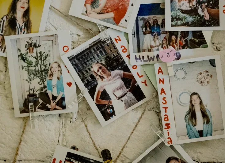 Instant photographs of guests pinned to a board.