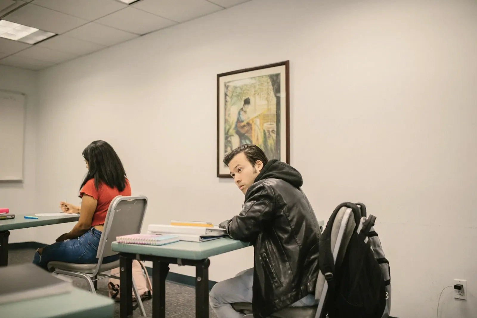 A small group class with course materials open on the table.