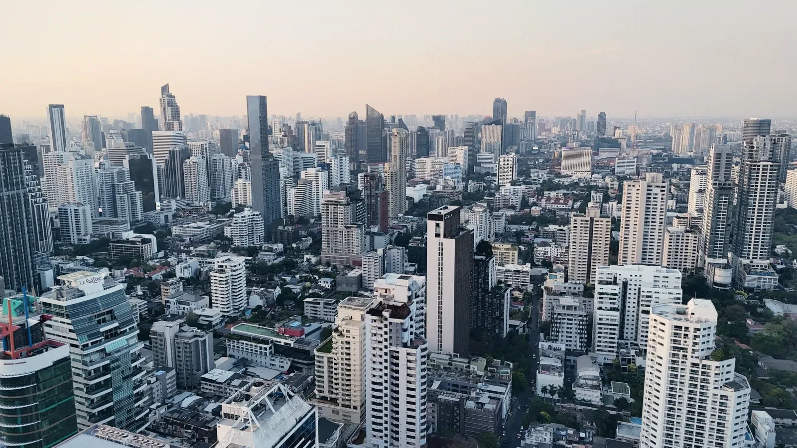 A wide aerial of a city and its river, standing in for the drawn coverage map.