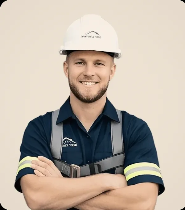 A roofer in a white helmet, arms crossed.