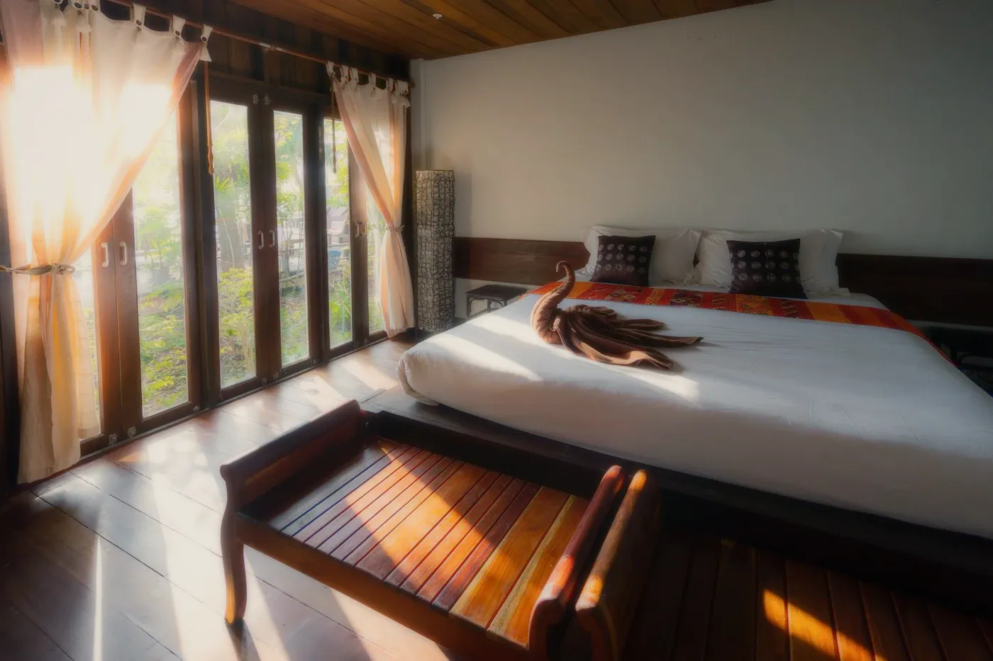A room with wooden floors and a bright window.