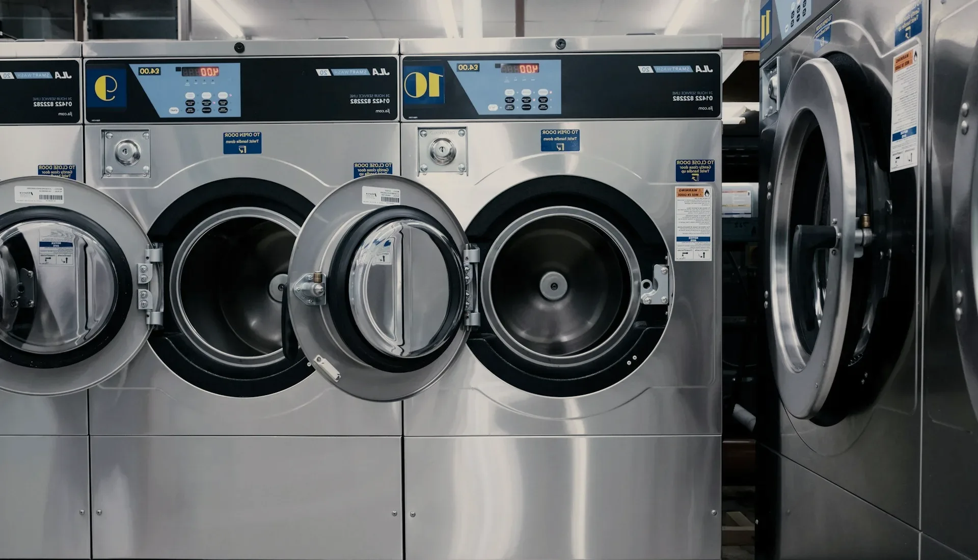 A row of front-loading washing machines.